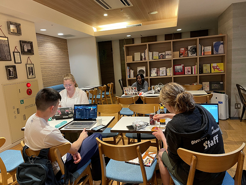 Three students studying together at table