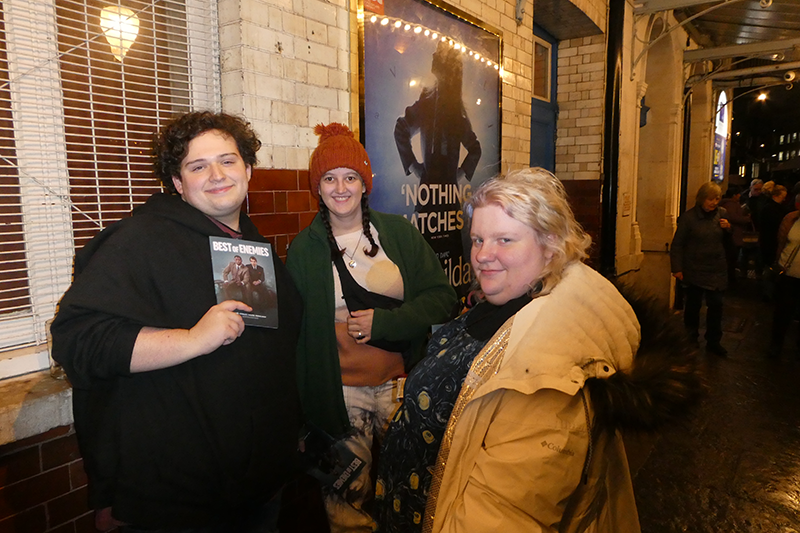 3 students outside theater posing for a photo.